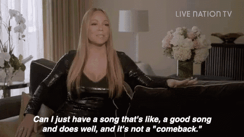 a woman is sitting on a couch talking about a song that is like a good song