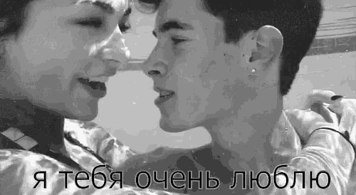 a black and white photo of a man and a woman kissing in the water