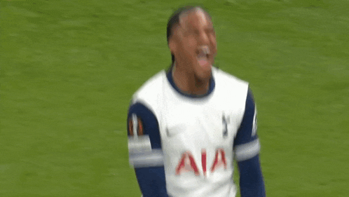 a soccer player wearing a white aia jersey