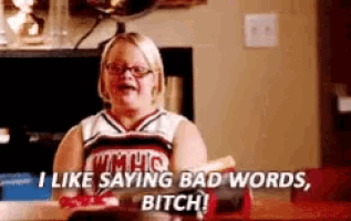 a cheerleader is sitting at a table and saying `` i like saying bad words , bitch '' .