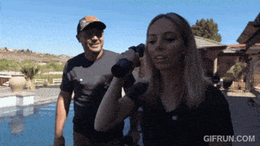 a gif from gifrun.com shows a man and a woman standing next to each other