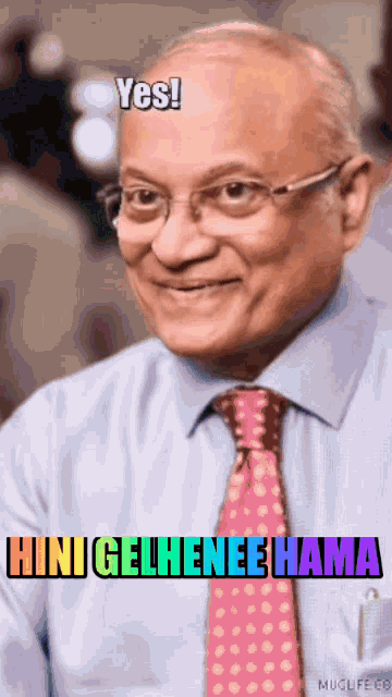 a man in a blue shirt and pink tie is smiling and says yes mini gelhenee hama