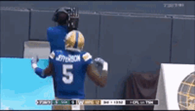 a football player in a blue jersey with the number 5 on the back