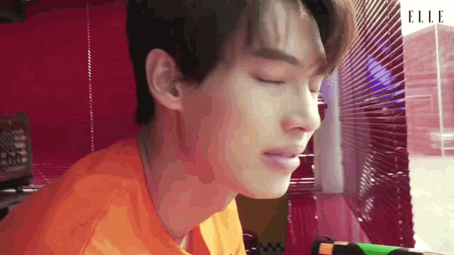 a close up of a man 's face with the word elle on the bottom right