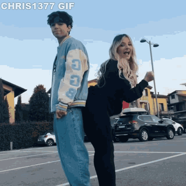 a man and a woman standing back to back in a parking lot with chris1377 gif written below them