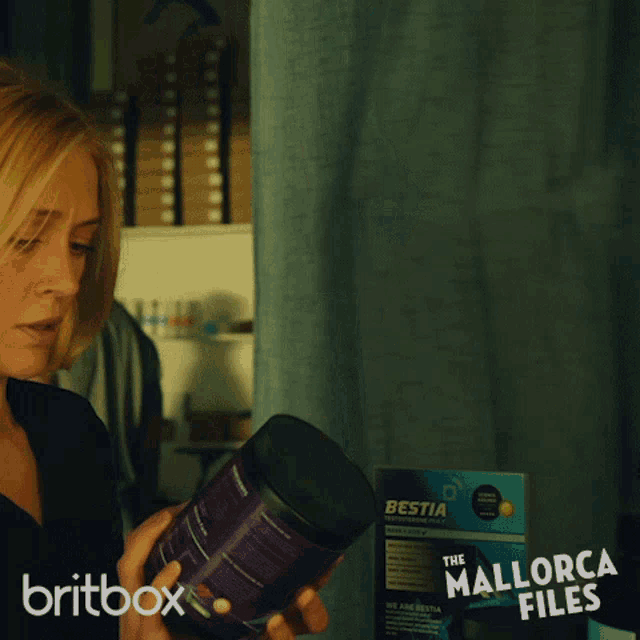 a britbox ad for the mallorca files shows a man and woman looking at a box