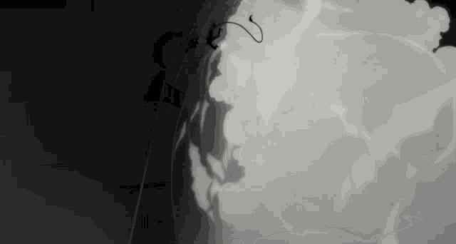 a black and white photo of a shadow of a person on a wall