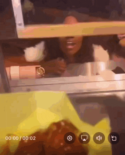 a video of a woman behind a glass window with the time of 00:00:02