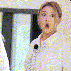 a woman in a white shirt and tie is making a funny face .