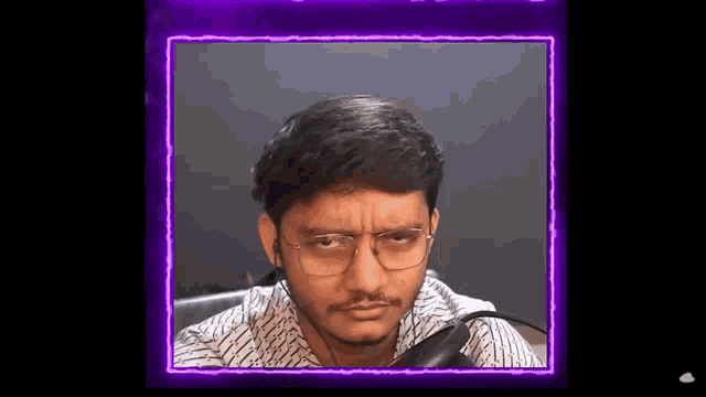 a man with glasses and a beard is making a funny face