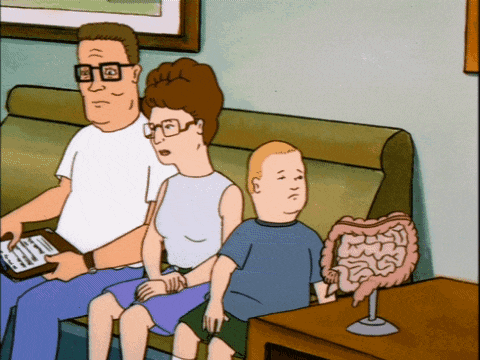 a cartoon of a family sitting on a couch with a model of their intestines