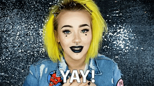 a girl with yellow hair and black lipstick says " yay "
