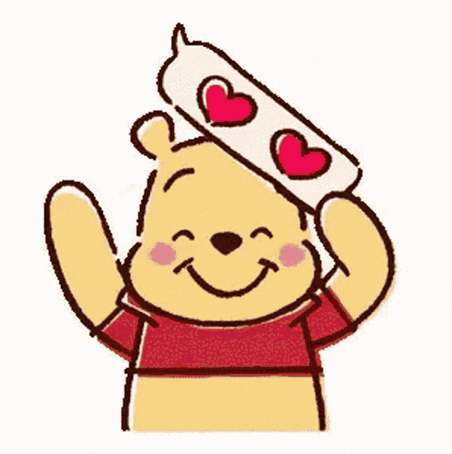 winnie the pooh is wearing a speech bubble with hearts on it .
