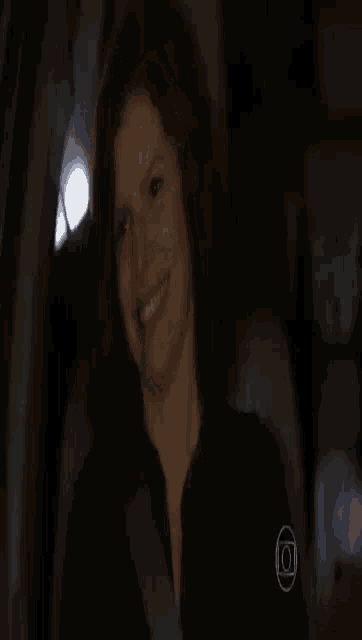 a woman is smiling in the back of a car