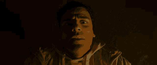 a close up of a man 's face in the dark