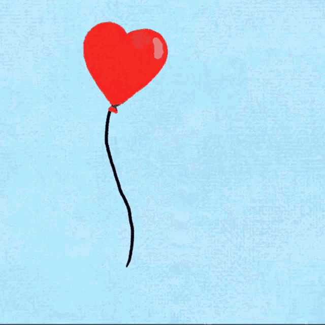 a red heart shaped balloon is floating in the air on a blue background