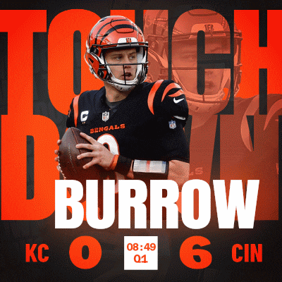 a bengals football player is holding a football in his hands