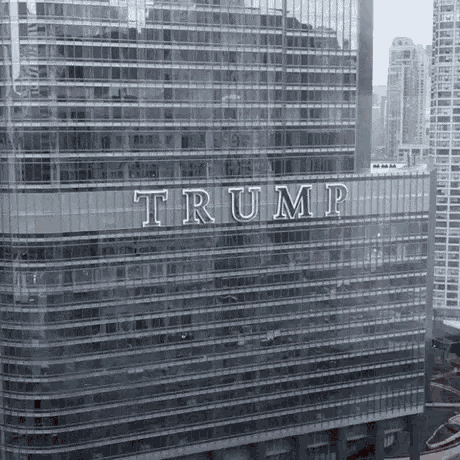 the word trump is on the side of a tall building