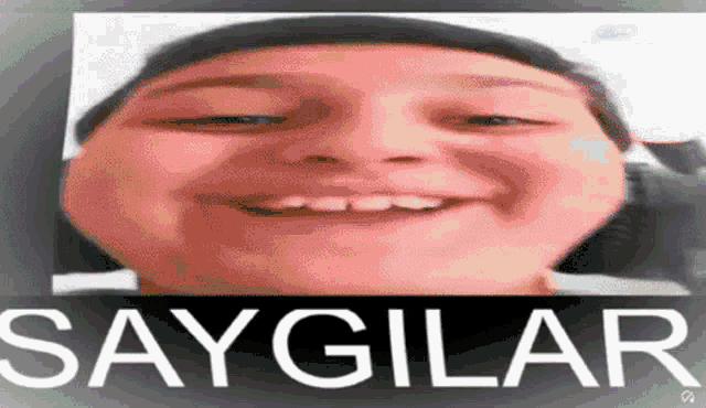 a close up of a person 's face with the words saygilar on the bottom .