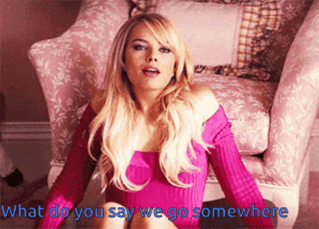 a woman in a pink sweater is sitting in a chair with the words " what do you say we go somewhere " written below her
