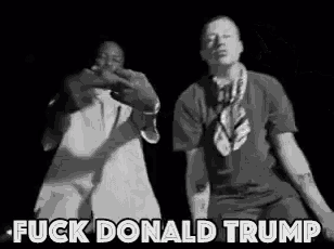 two men are dancing in a black and white photo with the words `` fuck donald trump '' written on the bottom .