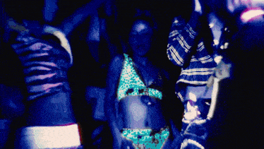 a woman in a leopard print top and fur coat stands in front of a sign that says ' tribe '