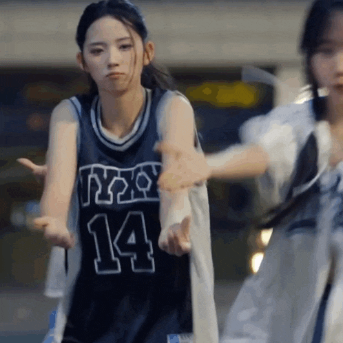 a girl wearing a jersey with the number 14