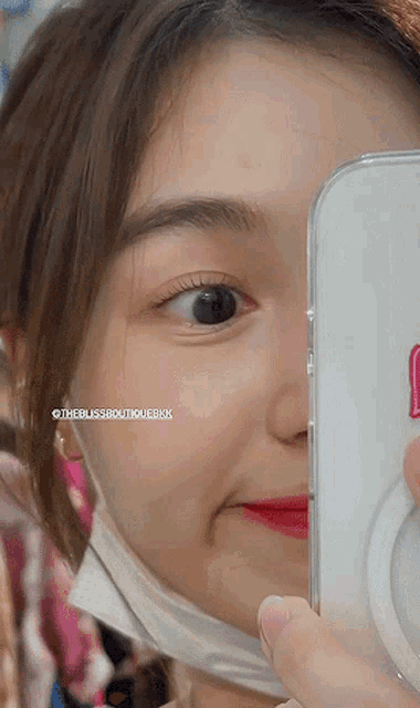 a close up of a woman 's face with the bliss3boutiquebkk written on the bottom