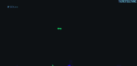 a woman with neon green hair is dancing in the dark .