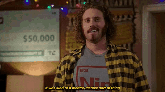 a man standing in front of a check that says $ 50,000