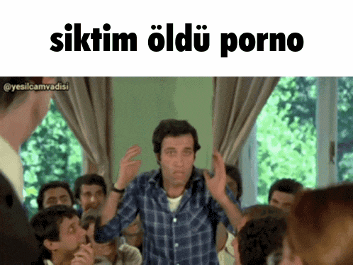 a man in a plaid shirt stands in front of a group of people with the words " siktim oldu porno " written above him