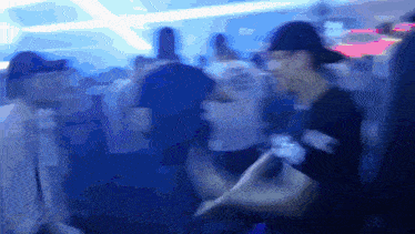 a blurry picture of a crowd of people with a man wearing a hat that says ' a.m. ' on it