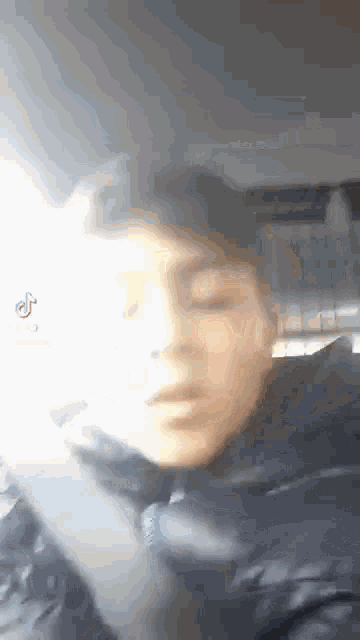 a close up of a person 's face with their eyes closed .