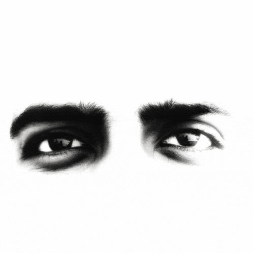 a close up of a man 's eyes with a white background