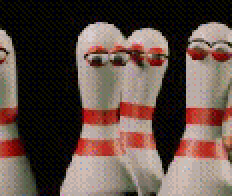 a row of bowling pins with red and white stripes