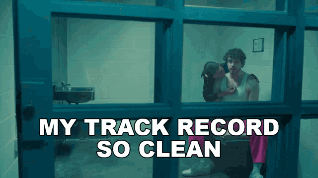 a picture of a man in a jail cell with the words my track record so clean