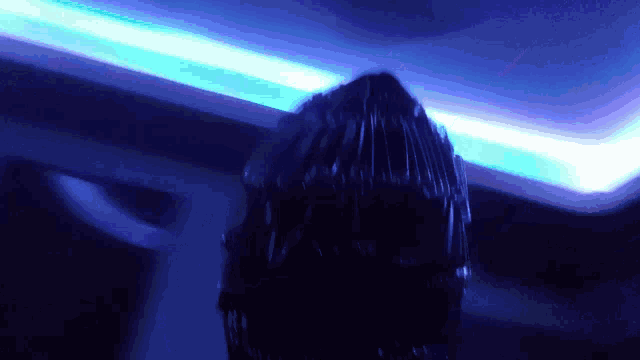 a blue light is shining on a dark room