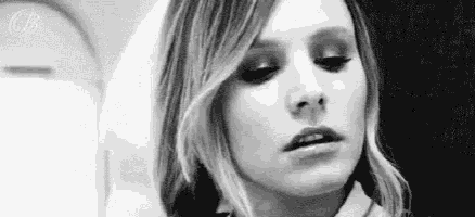 a close up of a woman 's face in a black and white photo with her eyes closed .