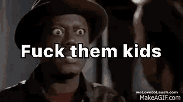a man in a hat is talking to another man with the words `` fuck them kids '' written on his face .