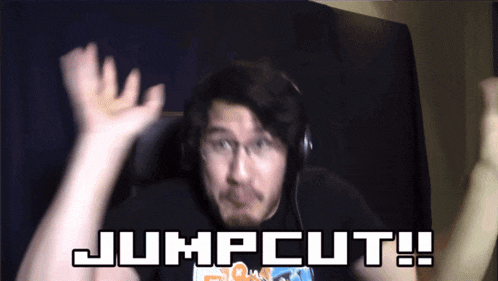 a man wearing headphones and a shirt that says jumpcut on it