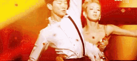 a man and woman are dancing on a stage .
