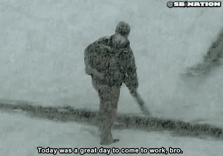 a man is running in the snow with a backpack on his back .