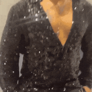 a close up of a person 's chest in a black shirt