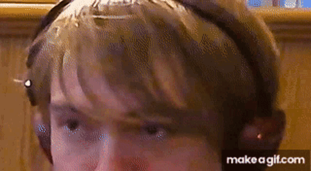 a close up of a person 's face with a headband on .