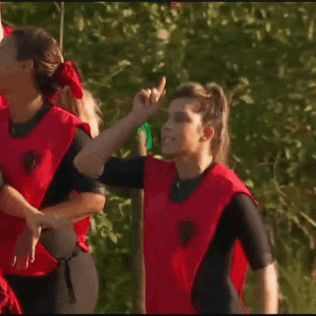 a group of women in red shirts are standing next to each other