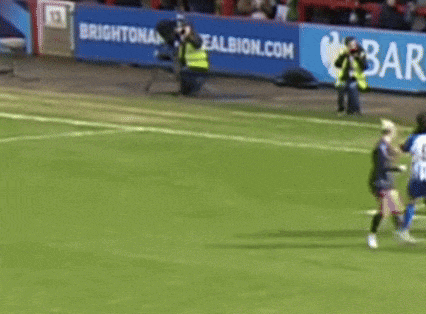 a soccer game is being played in front of a brighton and albion advertisement