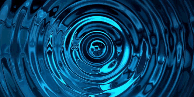 a close up of a blue water ripple on a black background