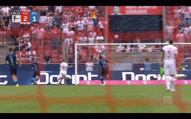 a soccer game is being played with a score of 2-1
