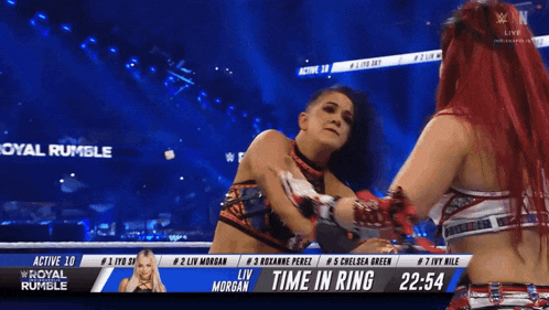 two women wrestling in a ring with the time in ring displayed