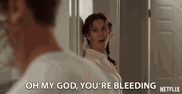 a woman says oh my god you 're bleeding in front of a man shaving